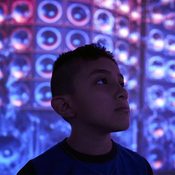 Kid in front of a digital wall of sound